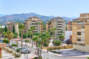 a city with palm trees and buildings at Playa Algarrobo Costa in Algarrobo-Costa