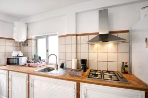 a kitchen with a sink and a stove top oven at Estudio La Morena in El Pris +14 photos