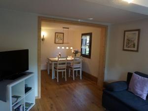 a living room with a table and a dining room at Ferienhaus am Leiselbach in Leisel +12 photos