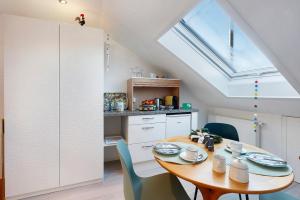 a kitchen with a table and chairs and a skylight at Haus Frank in Wehr