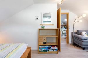 a bedroom with a bed and a couch and a chair at Haus Frank in Wehr