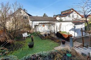 a backyard with a garden with a bench and a house at Haus Frank in Wehr