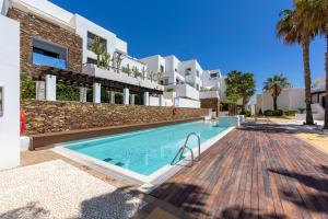a swimming pool in front of a villa at Duplex jlc in Mojácar