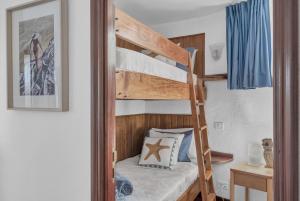 a bunk bed in a room with a bunk bed in a bedroom at Villalmar in Famara +36 photos