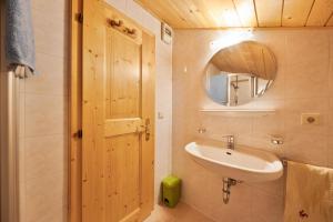 a bathroom with a sink and a mirror at Wieserhof Ferienwohnung Priml in Sarntal