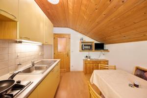 a kitchen with a sink and a counter top at Wieserhof Ferienwohnung Priml in Sarntal