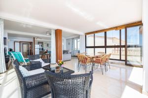 a living room with chairs and a table with a view at Brisas Vista Mar in Sa Ràpita