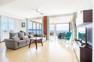 a living room with a couch and a table at Brisas Vista Mar in Sa Ràpita