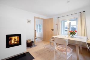 a living room with a table and a fireplace at Armenhaus 1828 in Görisried