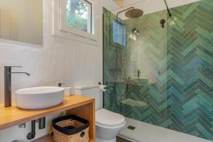 a bathroom with a sink and a shower and a toilet at Cabañas Entre Castaños in Jubrique +33 photos