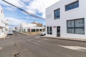 an empty street in a city with white buildings at Sparrow in La Santa