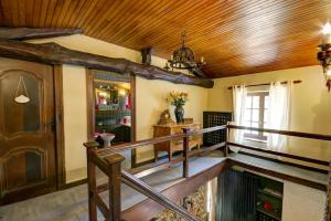 a staircase in a house with a wooden ceiling at Gîte Des Roties in Poncins +10 photos