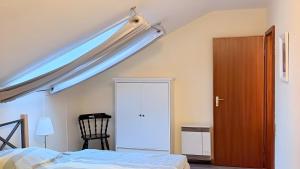 a bedroom with a bed and a skylight at Ferienwohnung Schöntal in Ludwigswinkel