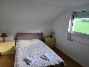 a bedroom with a bed with two towels on it at Apartmani Gradac in Valjevo