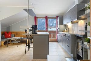 a kitchen with a counter and a table in it at Xxl-appartement Moarhof in Sand in Taufers