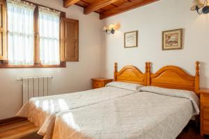 a bedroom with a large bed and a window at Casa Collado Santo Tomás in El Collado