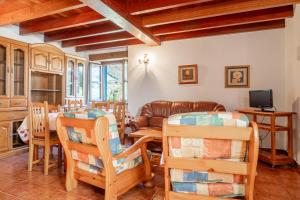 a living room with a couch and a table and chairs at Casa Collado Santo Tomás in El Collado