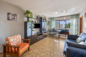 a living room with a couch and a dining room at Casa Carolina Y Roger Tazacorte in Tazacorte