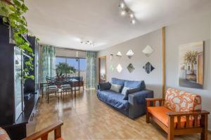 a living room with a blue couch and a table at Casa Carolina Y Roger Tazacorte in Tazacorte