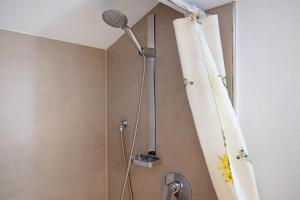 a shower in a bathroom with a shower curtain at Haus am See - Wohnung Jenner in Schönau am Königssee +19 photos