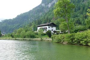 a house on the side of a river at Haus am See - Wohnung Jenner in Schönau am Königssee