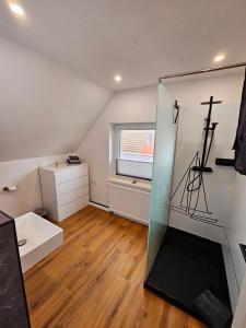 a bathroom with a glass shower in a room at Hus Matje in Langeneß +2 photos