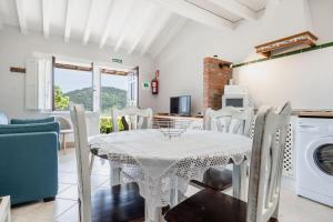 a kitchen and dining room with a white table and chairs at Las Candelas - Las Sopeñas in Oreña +28 photos