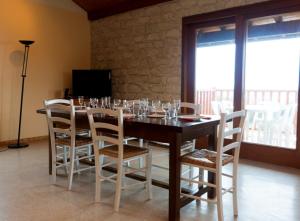 a dining room with a table with wine glasses on it at Gîte Télégraphe, Sonnay in Sonnay