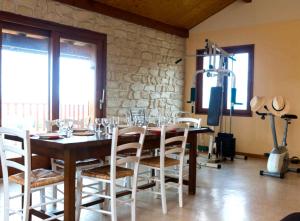 a dining room with a table with chairs and a television at Gîte Télégraphe, Sonnay in Sonnay