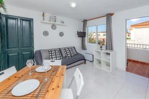 a living room with a table and a couch at Tranquilo apto con preciosa cala in Cala en Forcat