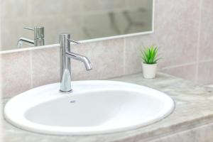a white bathroom sink with a faucet and a mirror at Tranquilo apto con preciosa cala in Cala en Forcat +21 photos