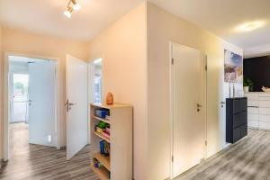 a room with white cabinets and a kitchen at Ferienwohnung Goldstadtblick in Pforzheim +30 photos