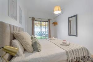 a bedroom with a large white bed with a window at Apartamento Luminoso Con Terraza in Puerto de la Cruz +25 photos