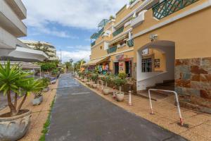 a street with potted plants next to a building at Apartamento Luminoso Con Terraza in Puerto de la Cruz