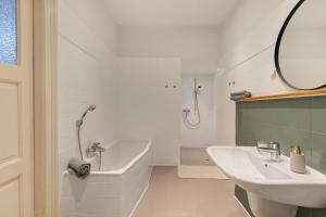 a bathroom with a tub and a sink and a bath tub at Sophienhof in Kronprinzenkoog +37 photos