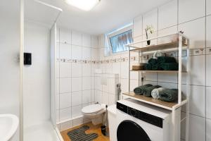 a small bathroom with a toilet and a sink at Ferienwohnung Knittlingen in Knittlingen +18 photos