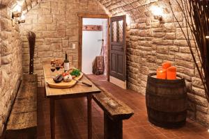 a room with a table with a bowl of food and a barrel at Ferienhaus Lilace in Böttingen