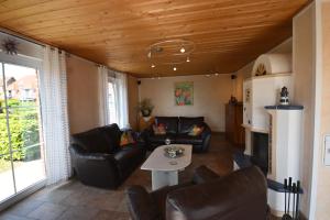 a living room with couches and a table at Haus Boddenperle in Breege