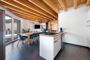 a kitchen and dining room with a table and chairs at Chalet Aussois Lerovi in Aussois