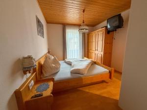 a small bedroom with a bed in a room at Die Kromarin in Kleinsölk