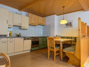 a kitchen with a table and a dining room at Die Kromarin in Kleinsölk