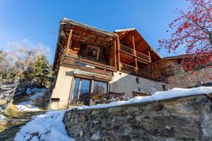 a log home in the winter with snow at L'Alpazen Jouve Duplex in Saint-Véran