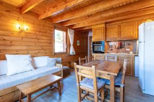 a kitchen and dining room with a table and a couch at L'Alpazen Jouve Duplex in Saint-Véran