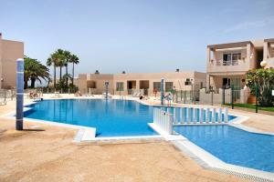 a large swimming pool in front of a building at Costa Bella la Tejita in La Tejita