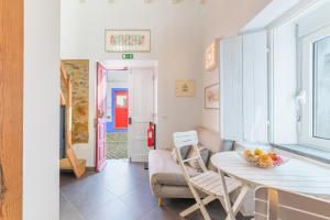 a kitchen and living room with a table and chairs at Casa Das Batatas in Odeceixe +16 photos