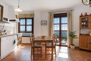a kitchen with a table and chairs in a kitchen at Cobijadas75 Segur in Vejer de la Frontera