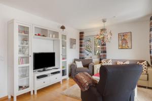 a living room with a tv and a couch at Ferienwohnung Christa in Sankt Märgen