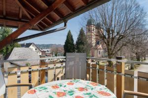 a table with a flower pattern on a balcony at Ferienwohnung Christa in Sankt Märgen