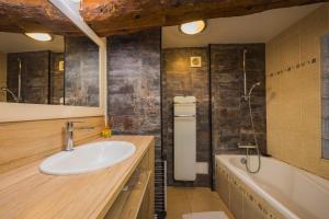 a bathroom with a sink and a bath tub at Gite d'Orgeix - Ax-les-Thermes in Orgeix +29 photos
