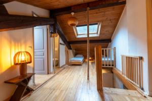 a room with a wooden ceiling with a window and a swing at Gite d'Orgeix - Ax-les-Thermes in Orgeix